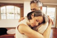 An older couple hugging